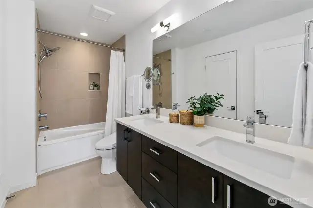 Primary bathroom has a dual vanity, soaking tub and tons of counterspace and storage.