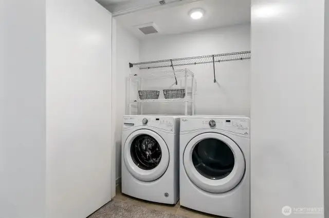 Laundry has extra space for folding and storage.