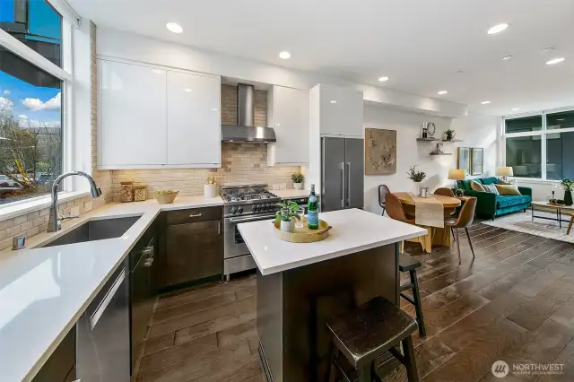 Kitchen welcomes you! Gas cooking, an added island for baking and entertaining, and window over the sink.