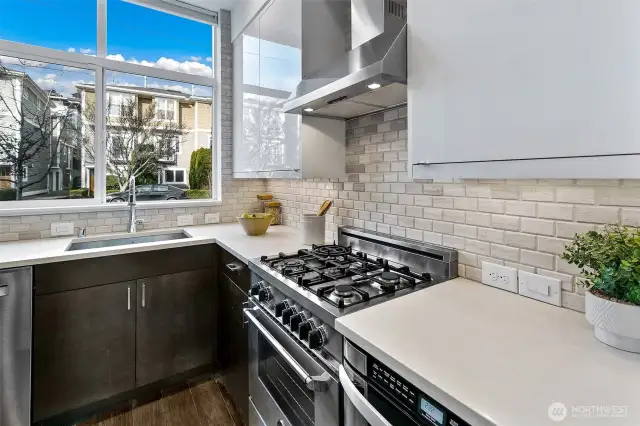 Kitchen welcomes you! Gas cooking, an added island for baking and entertaining, and window over the sink.