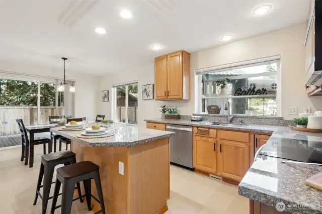 More good lighting and garden window lets in the daylight! Lots of granite counters, cabinets + pantry and center island together make for a very friendly kitchen!