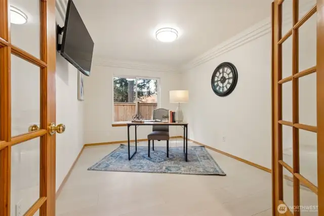 MAIN FLOOR DEN - could be used as additional bedroom. We appreciate the architectural touches such as glass double doors and triple ceiling molding. PLUS: TV on the wall stays!