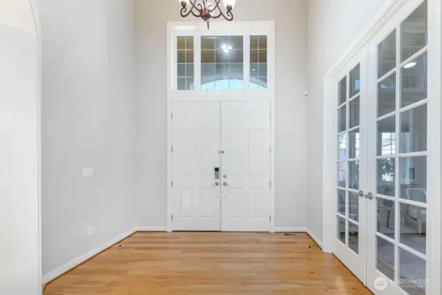 Elegant high ceiling foyer opens to above