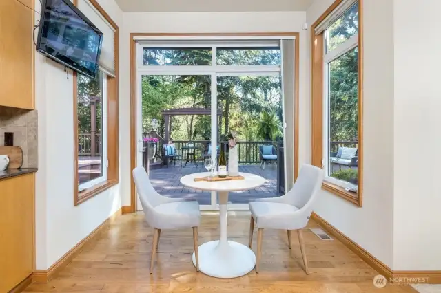 sunny breakfast nook looking out onto private backyard deck.