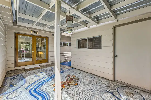 Private, covered patio with custom mosaic
