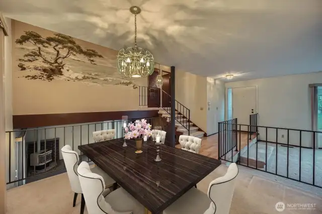 Dining room area connects to most of the home - downstairs is rec room area with gas fireplace, upstairs are bedrooms and bathrooms and behind the photo is the kitchen.   *Photo is virtually staged.