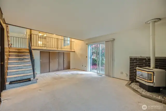 Lower level has gas burning fireplace, sliding glass door to backyard and storage cabinets with crawl space access.