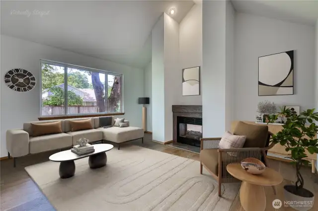 Formal living room is spacious with vaulted ceiling and 2-sided fire place and beautiful engineered hardwood floors.