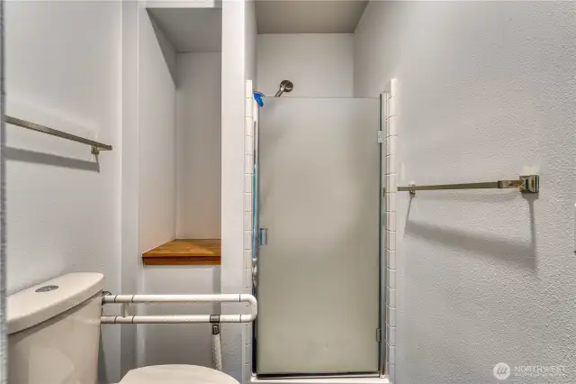 New raised height toilet with safety grab bar as well.