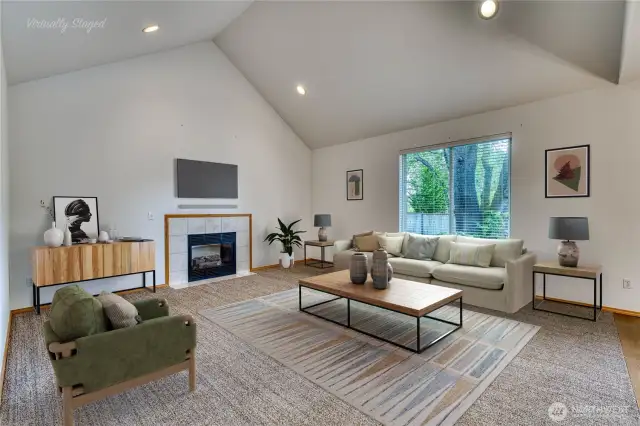 Family room with vaulted ceiling is spacious and bright.