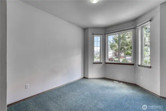 Additional bedroom on front of home with new carpet is light and bright.