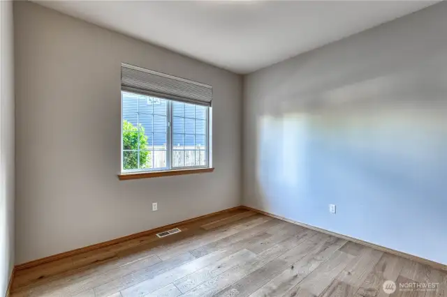 Second mainfloor bedroom with engineered hardwood flooring.