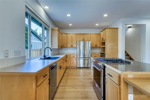Nicely updated kitchen with lots of counter space and cabinets with newer stainless appliances.  Notice lower counter top to the right for accessible access via wheelchair.