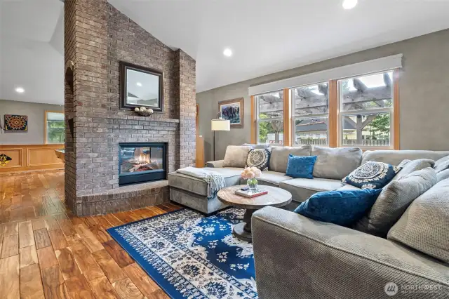 Double sided fireplace in great room/ billiard room