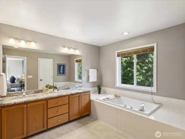 Primary bathroom with double sinks, oversized tub, shower & separate room for toilet
