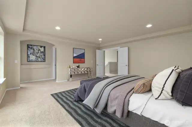Virtually staged primary bedroom with en suite bathroom.