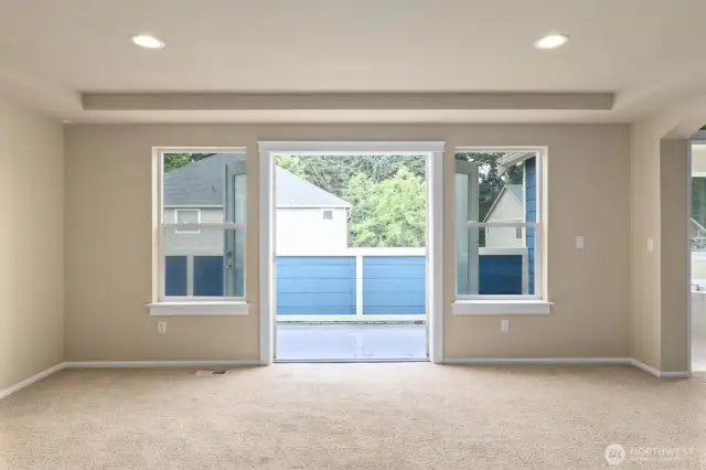 Primary bedroom French doors access to outdoor balcony space.