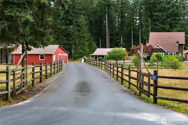 Lovely three rail farm fence leads you down the blacktop driveway off Martin Rd.