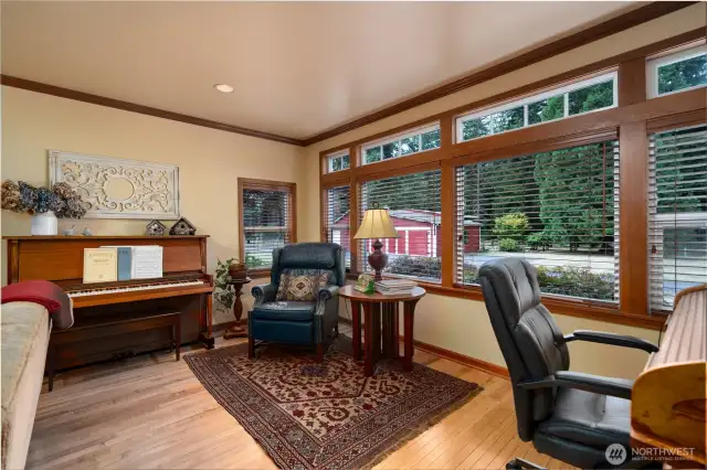 Living room is spacious and overlooks front driveway. Wood trim throughout.