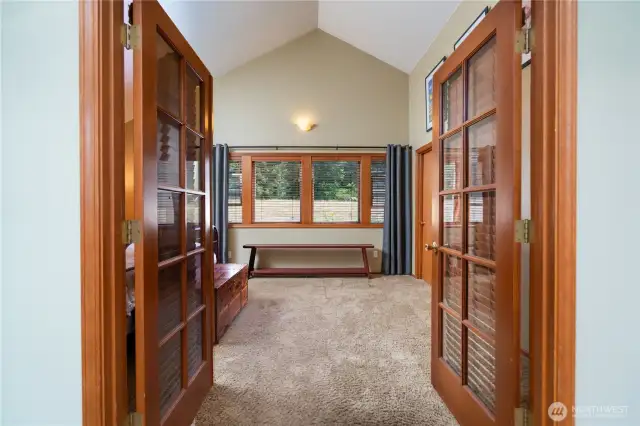 Primary bedroom has french doors to close off the adjacent living room.