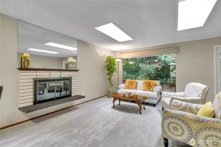 The living room is flooded with light and has a cozy gas fireplace...