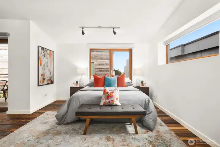 large primary bedroom with dramatic ceilings