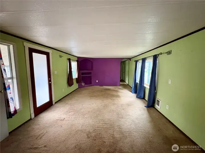 View of living room from the kitchen. (front entrance is door on left)