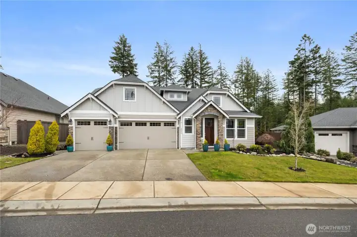 Craftsman-style exterior with stone accents, a 3-car garage, and strong curb appeal in the sought-after McCormick Woods community