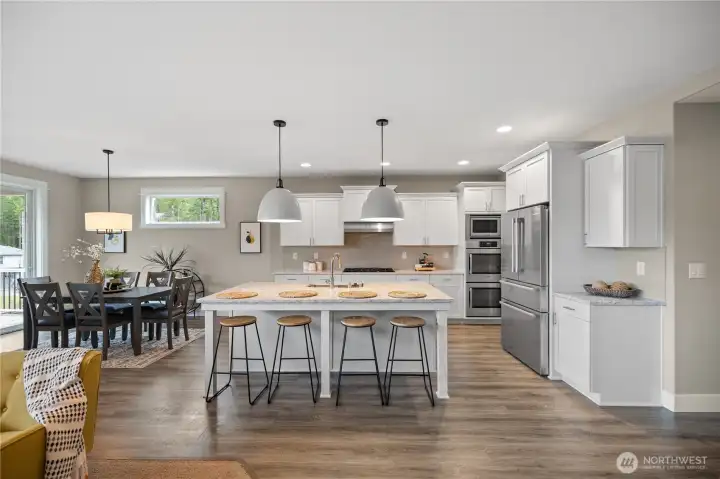 Modern kitchen designed for everyday living and entertaining, featuring island seating, abundant cabinetry, and clean finishes