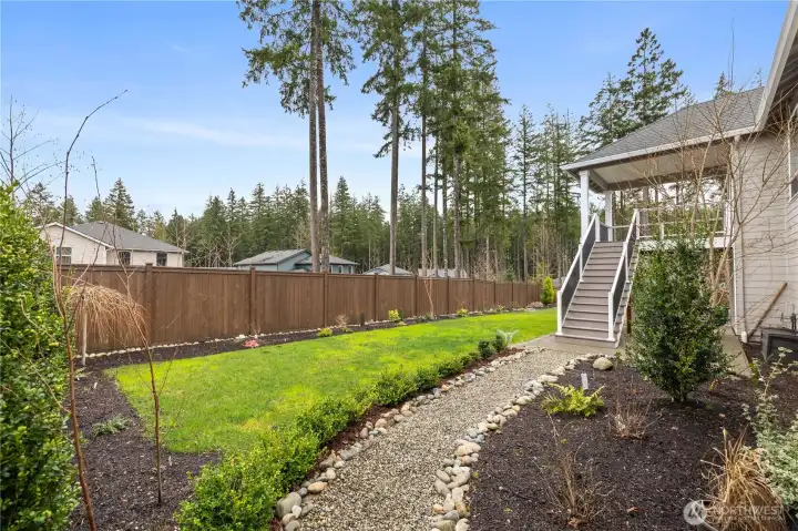 Terraced side-yard pathway and low-maintenance landscaping add flexibility and Northwest character to the property