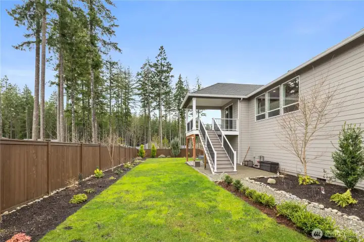 Usable, fully fenced lawn area offers a practical outdoor space that is easy to enjoy and maintain