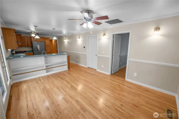 kitchen counter, pull up stools and store games in the open bookcase