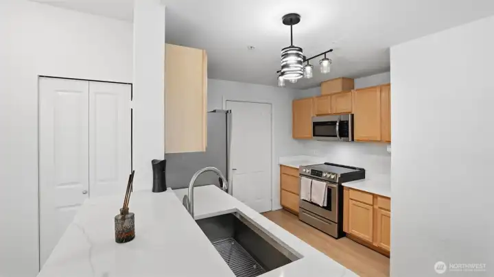 Enjoy a bright and functional kitchen featuring sleek stainless steel appliances and abundant cabinetry.