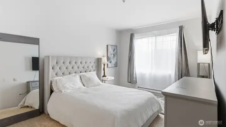 A beautifully appointed primary bedroom with generous space to unwind.