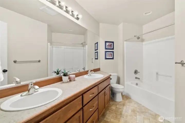 Full main bath with dual sinks and tub/shower combo upstairs