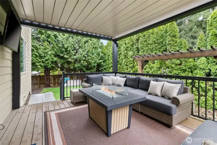 The sliding glass door off the kitchen leads to the covered backyard deck. The deck cover is louvered and opens electronically. Great for year-round use.