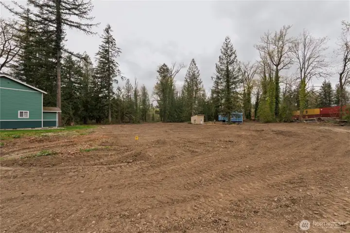 This cleared lot is ready for your custom home and is one of two available.  Tiny home in the background offers immediate flexibility, use it as a comfortable place to stay while you build. It's a great way to start enjoying the property right away while planning your dream build.