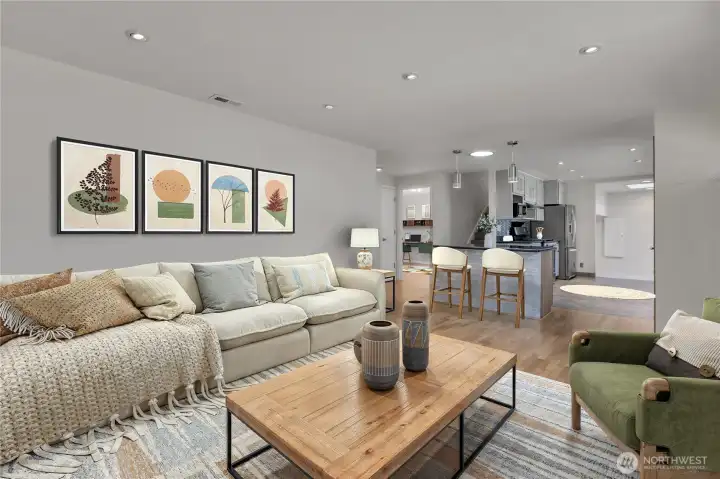 Open floor plan with kitchen Island a perfect spot for entertaining.  Plus note the light tube between the pendant lighting for extra warm natural light. Photo is virtually staged.