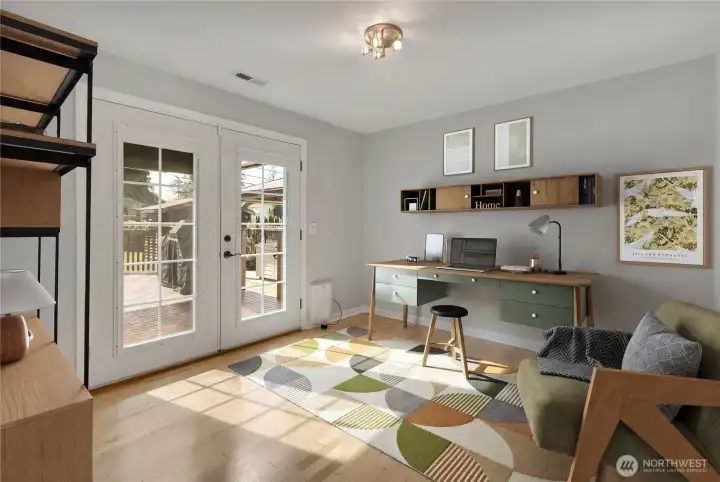 3rd Bedroom, Office or Den? Make it whatever room that best suits you.  French doors lead out to the back deck.  Photo is virtually staged.