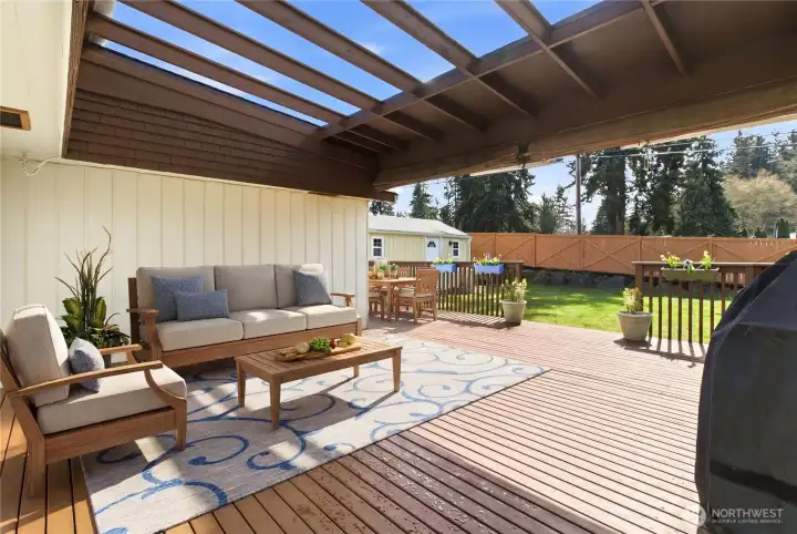 Spacious Covered Back deck is perfect for entertaining and is plumbed with gas and offers electric too!  There are side awnings that can lower if needed.  Photo is virtually staged.