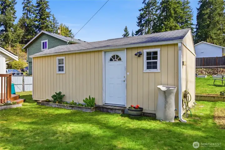 Huge shed has electric and large barn doors on the side for yard equipment, camping gear, holiday decor and more!