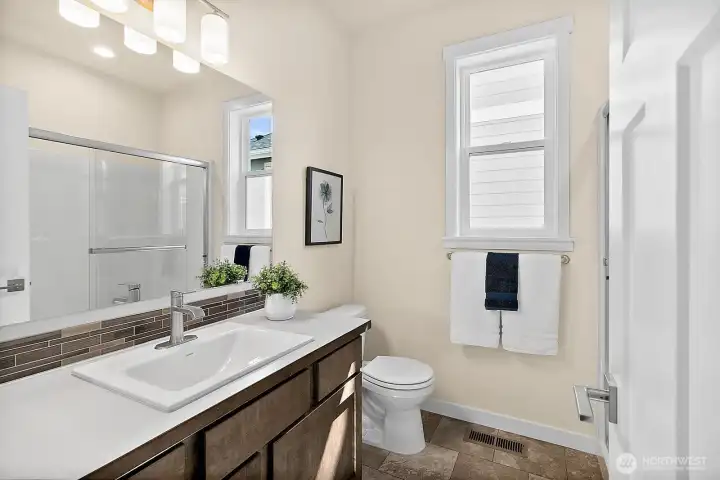 Main Floor Bathroom with ceramic tile and Quartz counters.