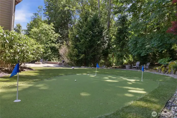 Enjoy your own backyard putting green, perfect for golf enthusiasts.