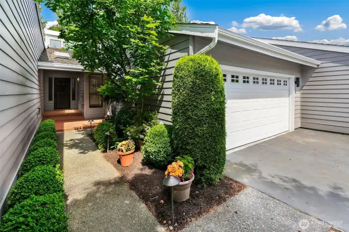 Inviting entry with established landscape