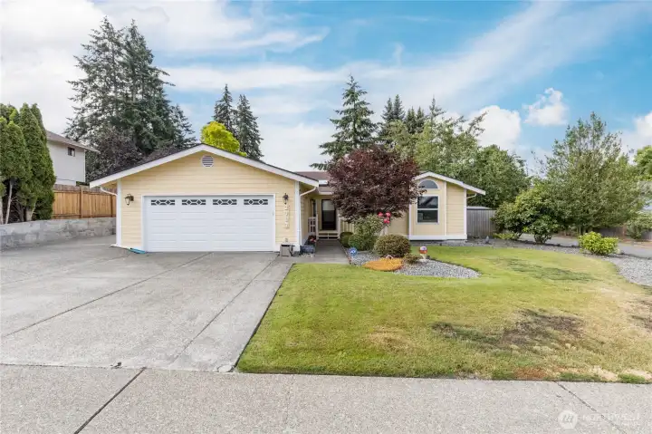 A frontal view of the home from the street; notice the large aggregate driveway, 2 car garage, and RV parking area to the left of the garage A frontal view of the home from the street; notice the large aggregate driveway, 2 car garage, and RV parking area to the left of the garage