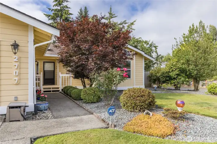 There is a covered porch, and mature landscaping There is a covered porch, and mature landscaping
