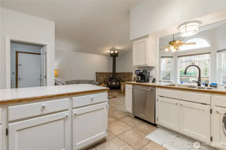 Another kitchen view, with extensive white cabinets, tile flooring, and stainless steel appliances Another kitchen view, with extensive white cabinets, tile flooring, and stainless steel appliances