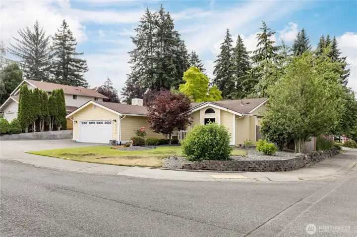 A view of the property emphasizing its corner lot position, and the low landscaping wall A view of the property emphasizing its corner lot position, and the low landscaping wall