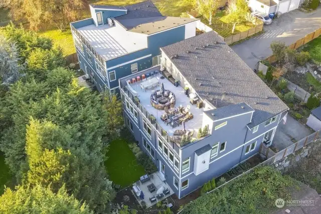 Aerial shot of the 773-sq.ft roof-top deck with views of Mt. Rainier & Cascades. The yard is fully-fenced with lovely neighbors all around! You will be delighted to call this abode, your home! A must see... Get in touch with your Agent!
