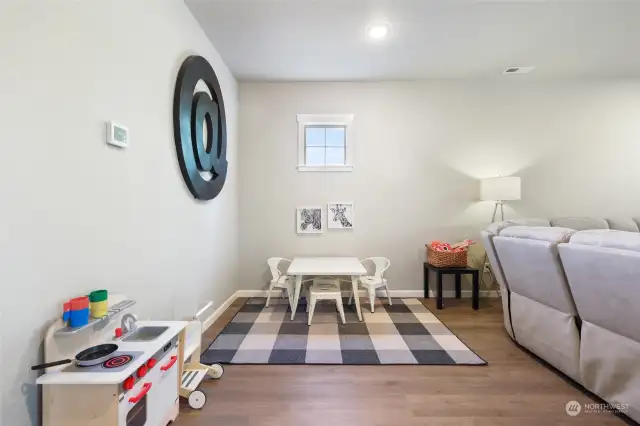 The living room size offers flexibility in uses for the space. In this case, play space is also kept tidy with helpful under-stair storage closet near by.